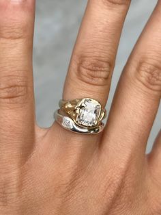 a woman's hand with a ring on it and a diamond in the middle