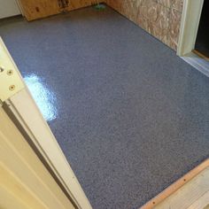 a door is open and there is a blue mat on the floor next to it