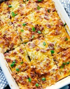 a casserole with ham and cheese in a white dish on a blue towel