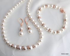 "This vintage inspired rose gold finish set comes with necklace, bracelet and earrings.  Austrian pearls in your color of preference. Makes a perfect gift for you, bridesmaids, maid of honor, mother of the bride or just for someone special! If you need a different color pearl contact me to check availability.  Perfect for any classy bride! Necklace, This classic and elegant necklace has graduated Austrian pearls. Pearls in the front of the necklace measure 10 mm and are separated with rhinestone roundelles, the rest of the pearls size ranges from 8 to 6 mm. Necklace measures approximately 17\" long and is finished off with a lobster claw clasp closure and 2\" extender chain for additional length. Bracelet, Pearls measure 8 mm, length is approximately 7.5\" inches long with a 1.25\" extende Mother Of The Bride Rose Gold Pearl Jewelry, Rose Gold Bridal Jewelry Set, Gold Bridal Jewelry, Classy Bride, Rose Gold Bridal Jewelry, Ivory Gown, Wedding Jewelry Set, Gold Bridal Jewellery Sets, Bridal Necklace Set