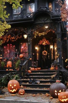 pumpkins on the steps in front of a house decorated for halloween