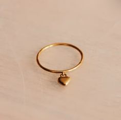 The cutest dainty ring with a dangly heart charm. Size: 6 Material: stainless steel, gold dipped Dangle Ring, Dainty Gold Rings, Hanging Hearts, Stainless Steel Ring, Charm Rings, Aesthetic Things, Gold Dipped, Rings Simple, Dainty Ring