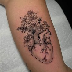 a black and white heart tattoo with flowers