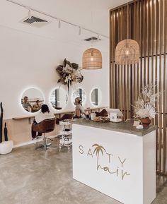 a hair salon with chairs and mirrors on the wall next to a counter that says safty hair