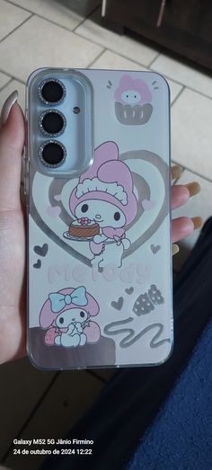 someone is holding up their phone case with hello kitty on it