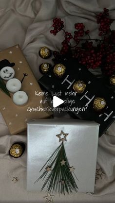 some chocolates are sitting next to each other on a bed with white sheets and christmas decorations