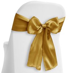 the back of a white chair with gold ribbon on it's sashes and bow