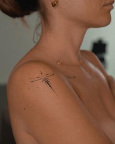 a woman with a small tattoo on her shoulder