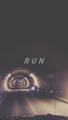 people are walking through a tunnel with the word run on it