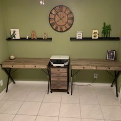 two desks in a room with a clock on the wall above them and other decorations