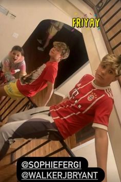 three young boys are sitting on the stairs and one is standing up with his foot in the air