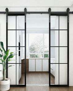 an open living room with sliding glass doors and wood flooring, along with a painting on the wall