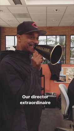 a man is talking into a megaphone in an office