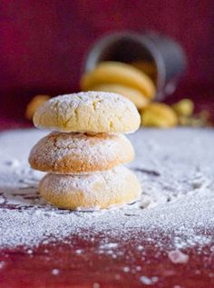 three powdered sugar cookies stacked on top of each other