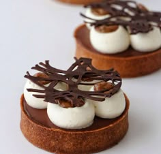 three small desserts with chocolate and marshmallow toppings