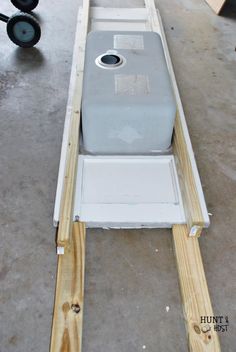 a large gray container sitting on top of a wooden pallet