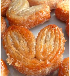 some very tasty looking doughnuts on a white plate with nuts in the middle