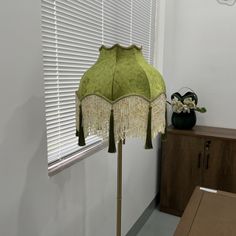 a lamp that is sitting next to a window