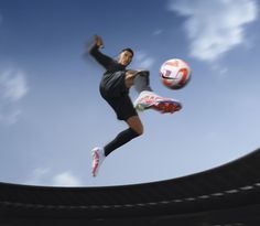 a man kicking a soccer ball in the air