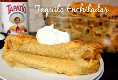 a white plate topped with food next to a bottle of taquito enchiladas