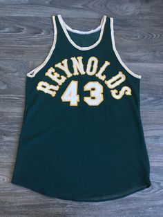 Vintage Basketball Jersey. This 60's era jersey has all sewn numbers/lettering. The material is thick, durable and stretchy. There are some faint marks at the trim--very minor, overall excellent vintage condition. Check out other fantastic vintage sports gear in my shop https://www.etsy.com/shop/sweetVTGtshirt?section_id=11916422&ref=shopsection_leftnav_5 Measurements (Inches): Pit to Pit: 17 1/2 Bottom Hem: 19 Outside shoulder seam to outside shoulder seam: 10 Total Length (Top of shoulder Cotton Jersey With Letter Print For Game Day, Cotton Letter Print Jersey For Game Day, Sleeveless Cotton Jersey For Sports Season, Sleeveless Cotton Jersey For Sports, Team Spirit Cotton Jersey With Letter Print, Throwback Cotton Jersey For Sports Events, Throwback Cotton Jersey With Letter Print, Cotton Sports Jersey With Letter Print, Cotton Jersey With Letter Print For Sports Season