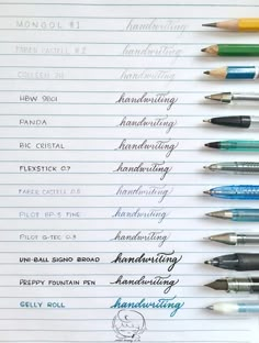 several fountain pens lined up on top of a piece of paper with writing in it