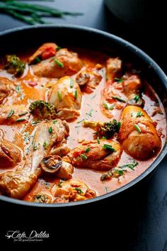 a pan filled with meat and vegetables covered in sauce