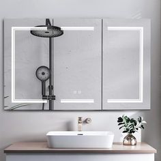 a bathroom sink sitting under a mirror next to a wall mounted faucet in front of it