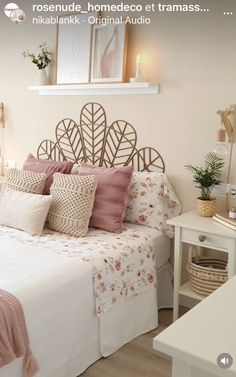 a bed with pink and white pillows in a bedroom