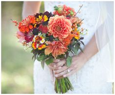 a bride holding a bouquet of flowers in her hands