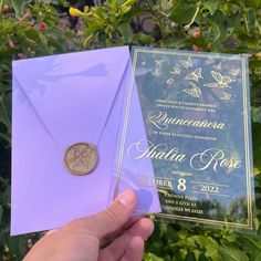 a person holding up a purple envelope with a coin on it and the inside of it