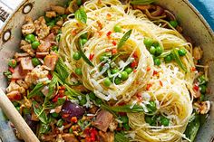 a bowl filled with pasta, meat and vegetables