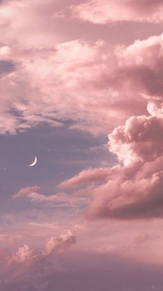 the sky is filled with clouds and a half moon