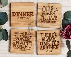 four wooden coasters with different sayings on them next to flowers and greenery