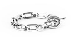 "Somewhat of an optical illusion, this silver bracelet features alternating hexagonal and box links, connecting together at the ends with a prominent toggle clasp. The contrasting geometry of this bracelet is alluring, and can serve as a highlight to one's every day outfit. The length of this bracelet is 8.5\" inches. (Length is measured from end to end.) Please message us if you would like a custom length. Available in Sterling Silver 925" Silver Bracelet With Polished Rectangular Links, Sterling Silver Bracelet With Rectangular Links And Polished Finish, Sterling Silver Bracelet With Polished Rectangular Links, Classic Bracelets With Rectangular Silver Chain Links, White Gold Link Bracelet With Box Clasp, Sterling Silver Chain Bracelet With Rectangular Links, Sterling Silver Bracelets With Rectangular Links Box Chain, Modern Rectangular Bracelet With Polished Finish, Modern Chain Link Bracelet With Hooks And Links