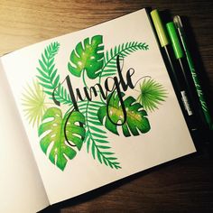 an open book with green leaves and the word jungle written in cursive writing