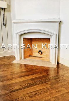 an empty room with a fireplace and wood flooring in it, that has the words artisan kraffit written on the wall