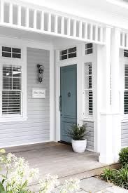 a white house with blue door and shutters