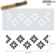 the stencil studio flower design is shown in black and white with a wooden handle