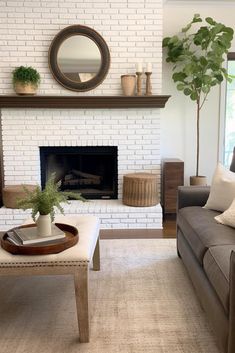 a living room filled with furniture and a fire place in front of a brick wall