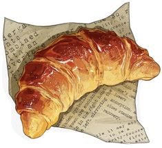 a croissant sitting on top of a piece of paper with writing underneath it