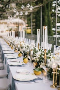 a long table with white and gold decorations