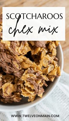 a white bowl filled with chocolate and peanut butter chex mix on top of a wooden table