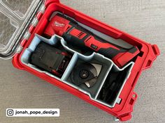 a red tool box filled with tools on top of a table