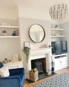 a living room filled with furniture and a flat screen tv mounted to a wall next to a fire place