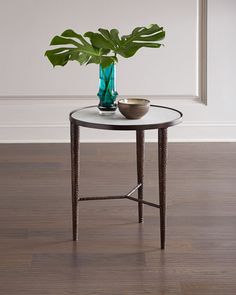 a glass table with a plant on top