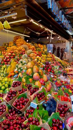 an outdoor market with lots of fruit and vegetables