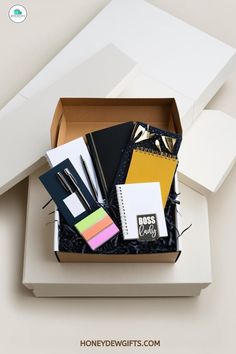 an open box filled with assorted stationery items