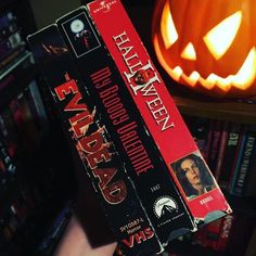 a person holding a halloween book in their hand