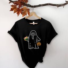 Halloween Ghost Shirt, Halloween Party Shirt, Floral Ghost Shirt, Autumn Shirt, Trick or Treat Shirt, Cute Ghost, Halloween Pumpkin Gift TEE INFORMATION: This t-shirt is soft and lightweight, with the right amount of stretch. It's comfortable and flattering! **Sizing is unisex** Fabric is pre-shrunk 100% combed and ring-spun cotton Halloween Novelty Short Sleeve Shirt, Cotton Halloween Costume Party Tops, Novelty Short Sleeve Shirt For Halloween, Pre-shrunk Long Sleeve Halloween Shirt, Spooky Long Sleeve Shirt For Halloween, Spooky Short Sleeve Shirt For Fall, Halloween Horror Long Sleeve T-shirt, Spooky Short-sleeve Fall Shirt, Funny Pre-shrunk Shirt For Halloween